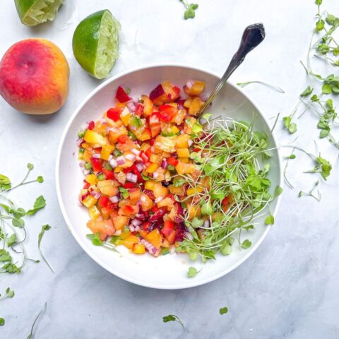 peach salsa in a bowl with ingredients