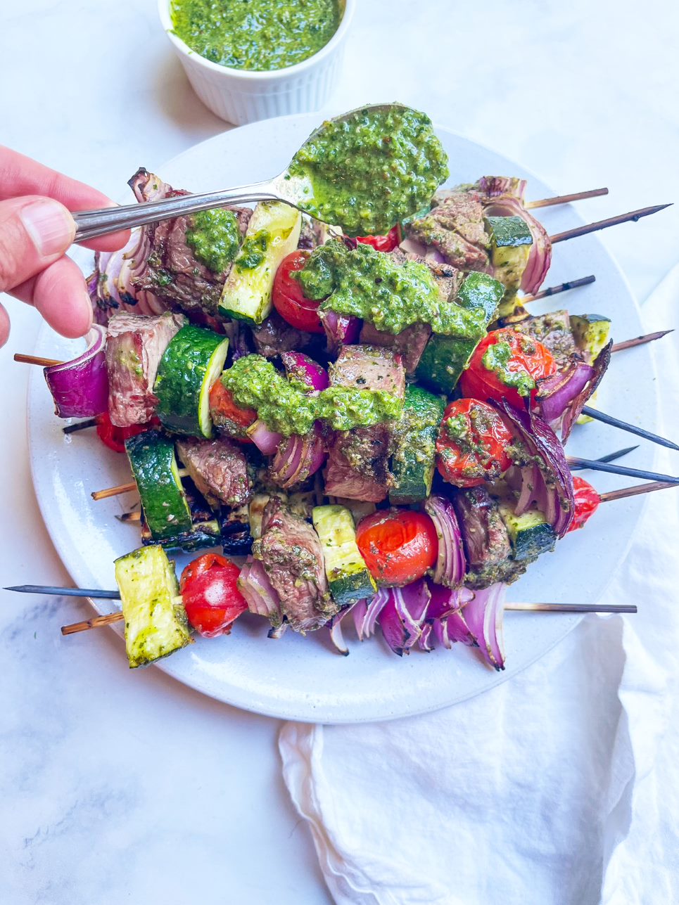 pesto steak kabobs with spoon of pesto