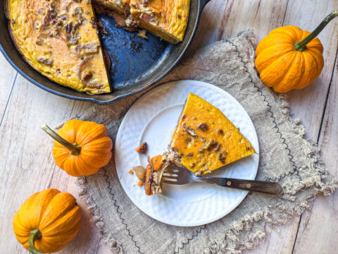 A slice of Pumpkin Apple Breakfast Bake lies on a plate