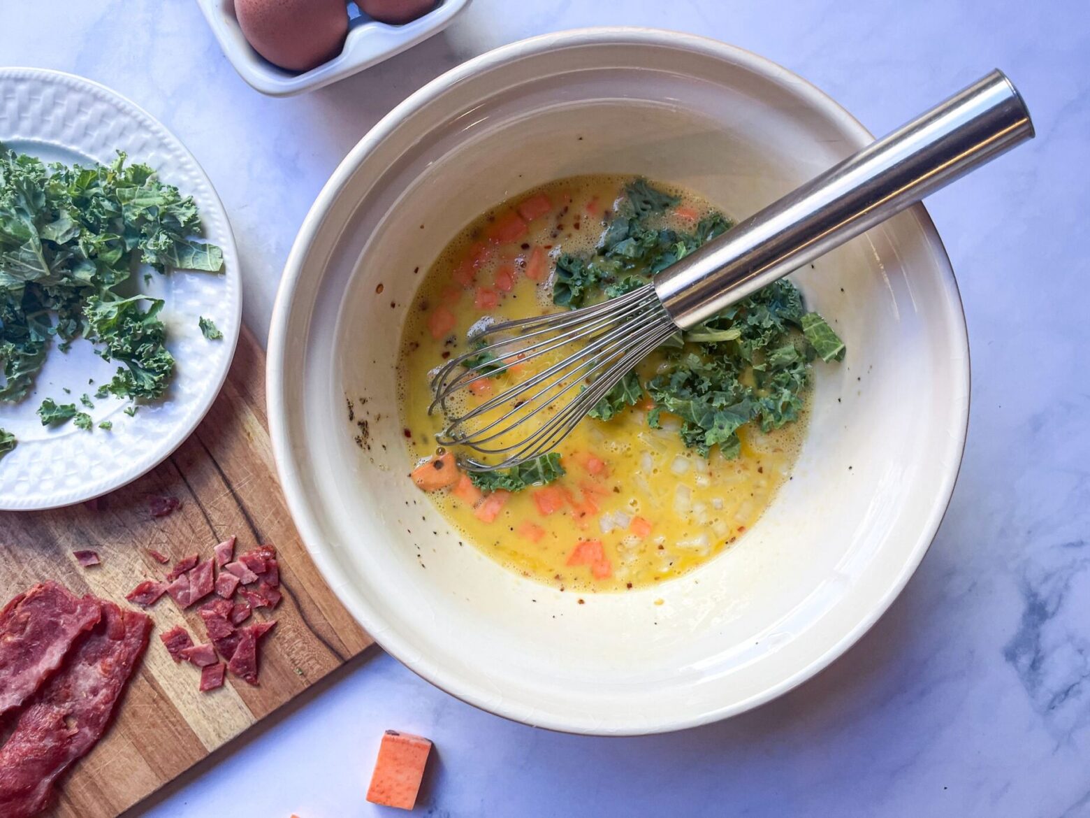 beating eggs with sweet potatoes and kale