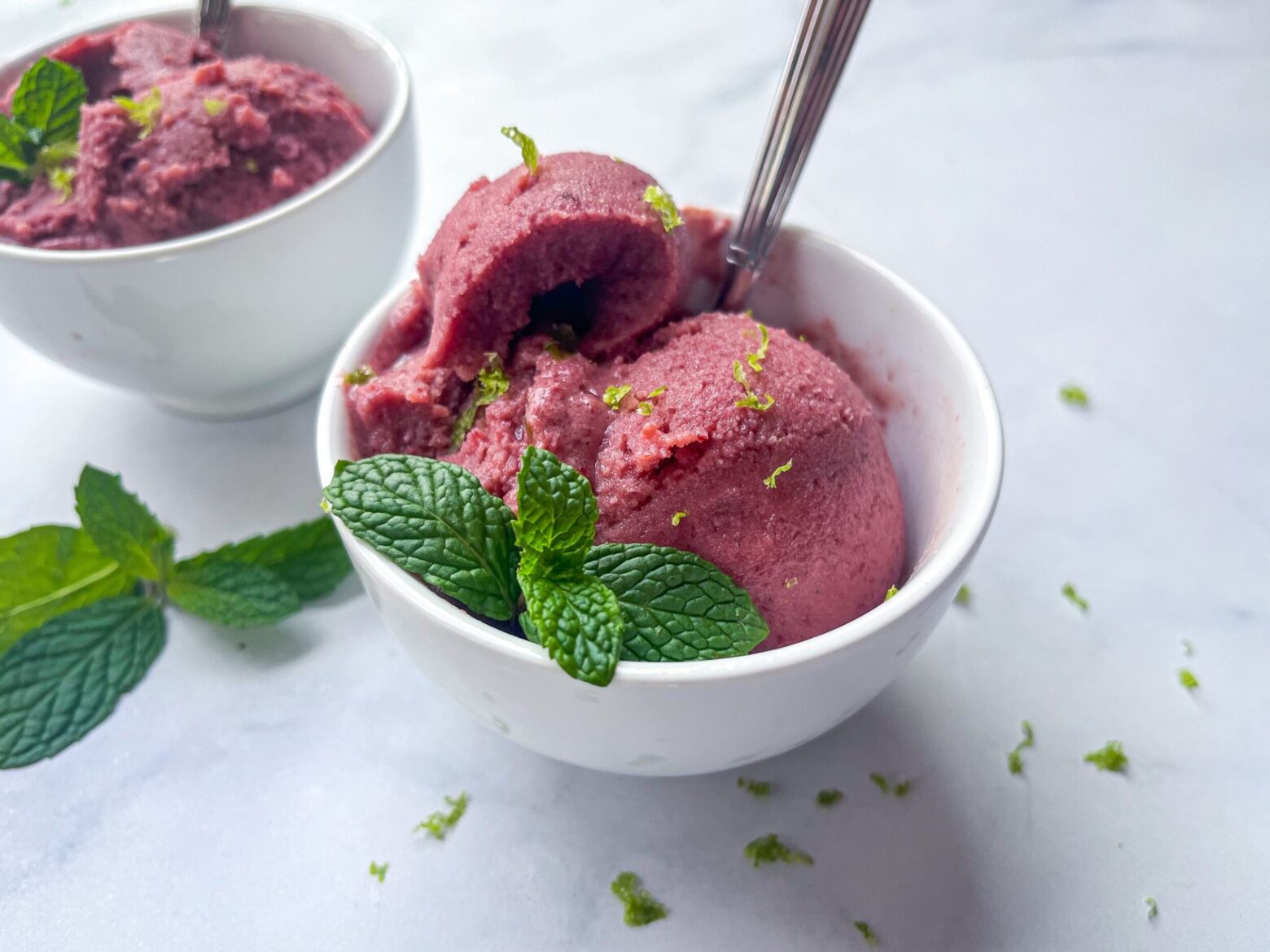 lime cherry sherbert in a bowl with a spoon