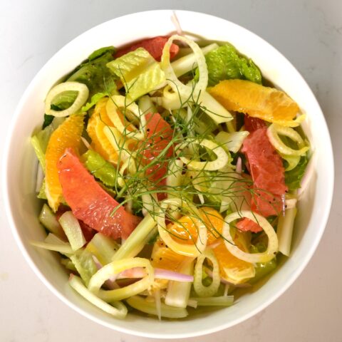 Above shot of a salad with slices of orange and grapefruit.