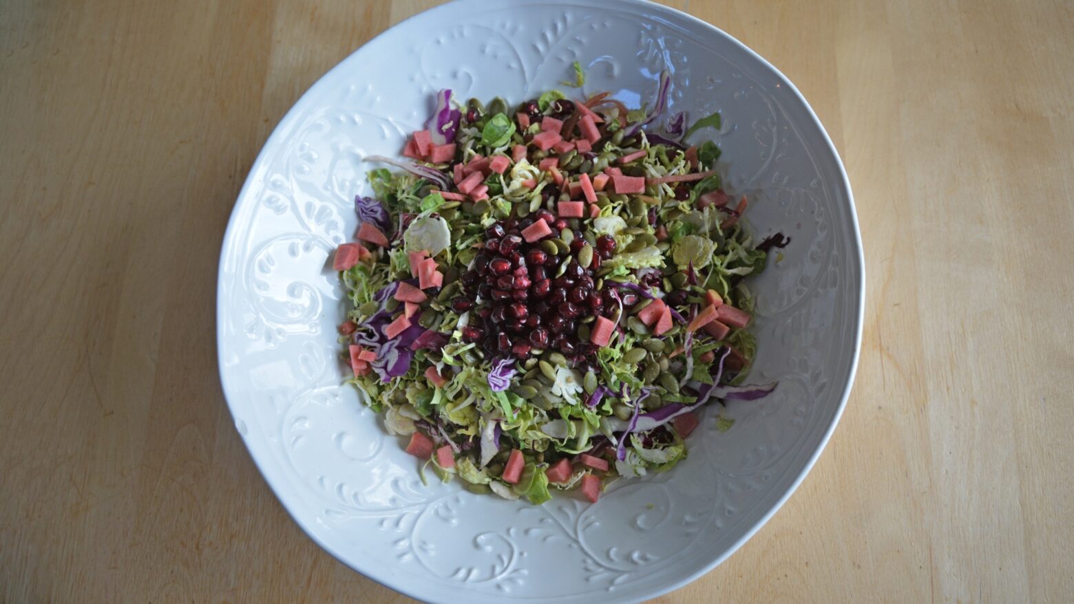 Above shot of a colorful salad topped with pomegranate seeds