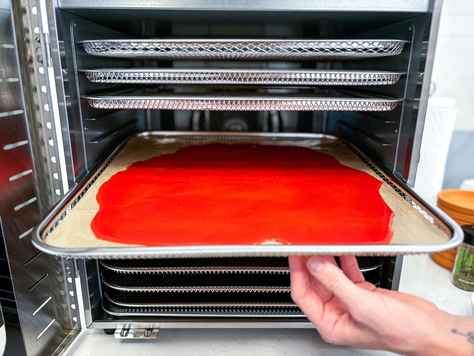 Fruit roll-ups being put into the dehydrater.