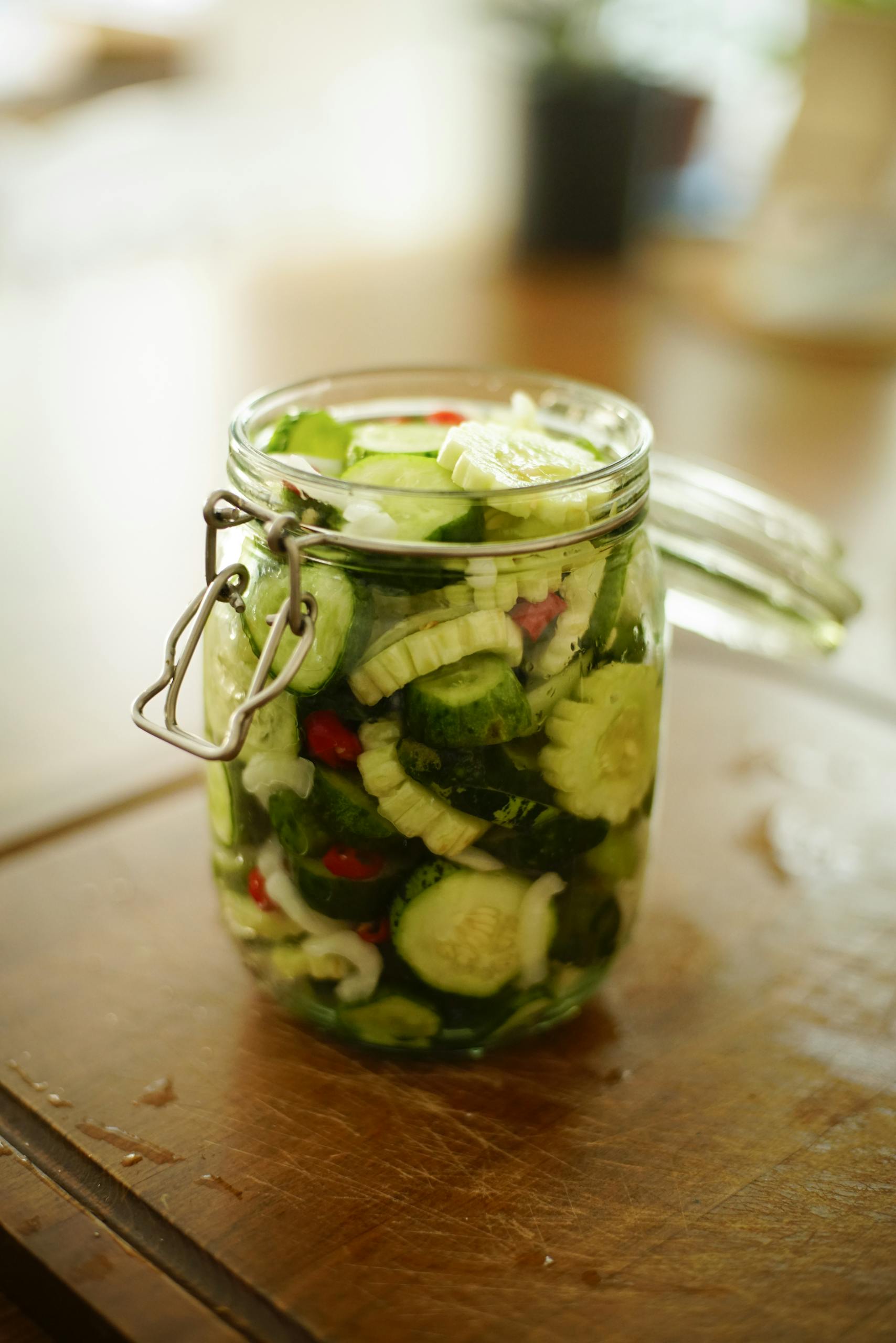 Close-Up Shot of Pickled Cucumber in Clear Glass Jar