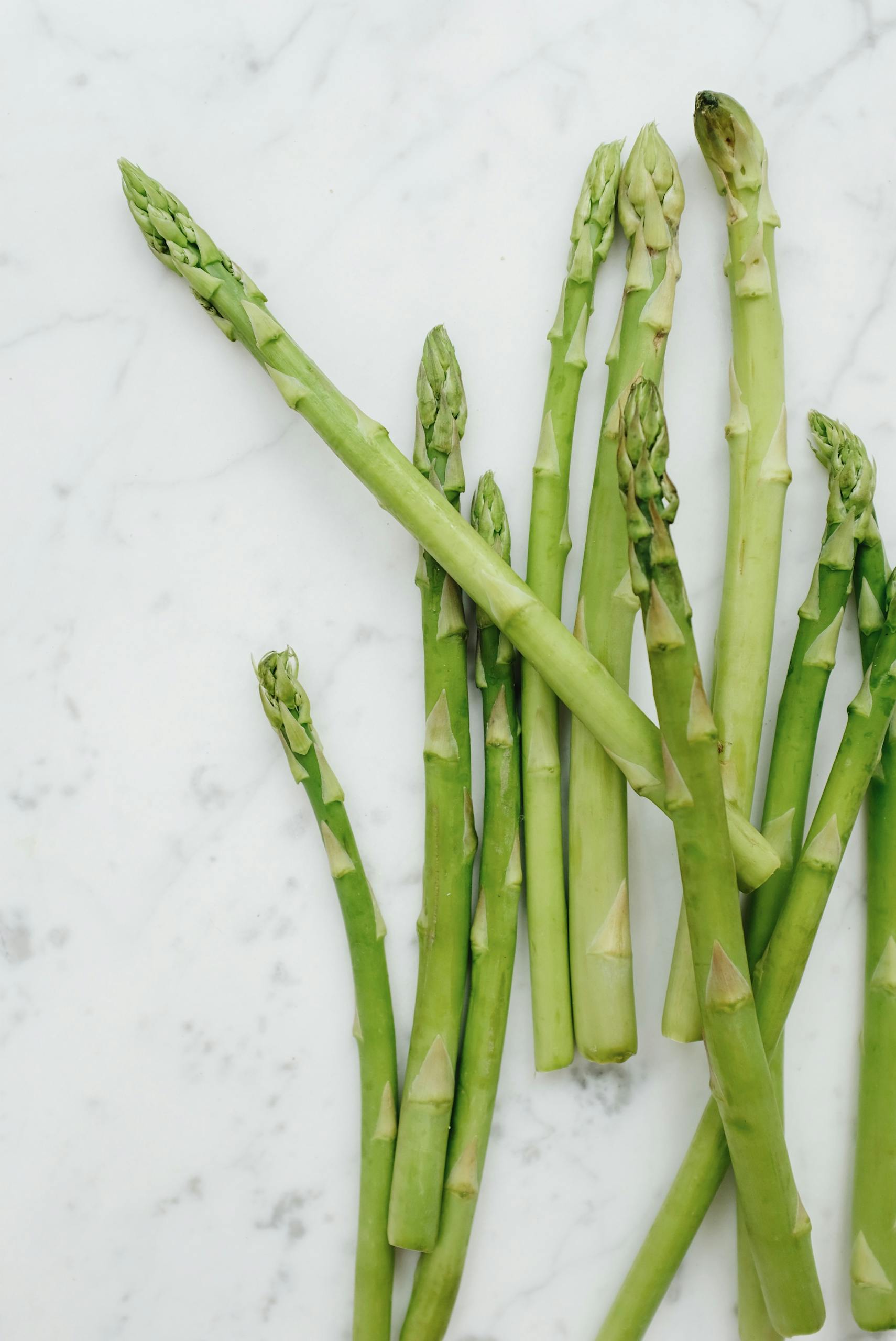 Asparagus spread out on the counter.