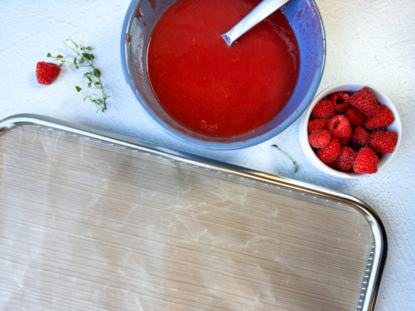 Preparing fruit roll-up mixture for the baking tray.