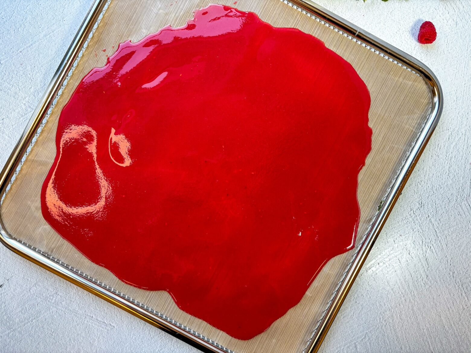 Raspberry-thyme fruit roll-ups on a baking sheet.