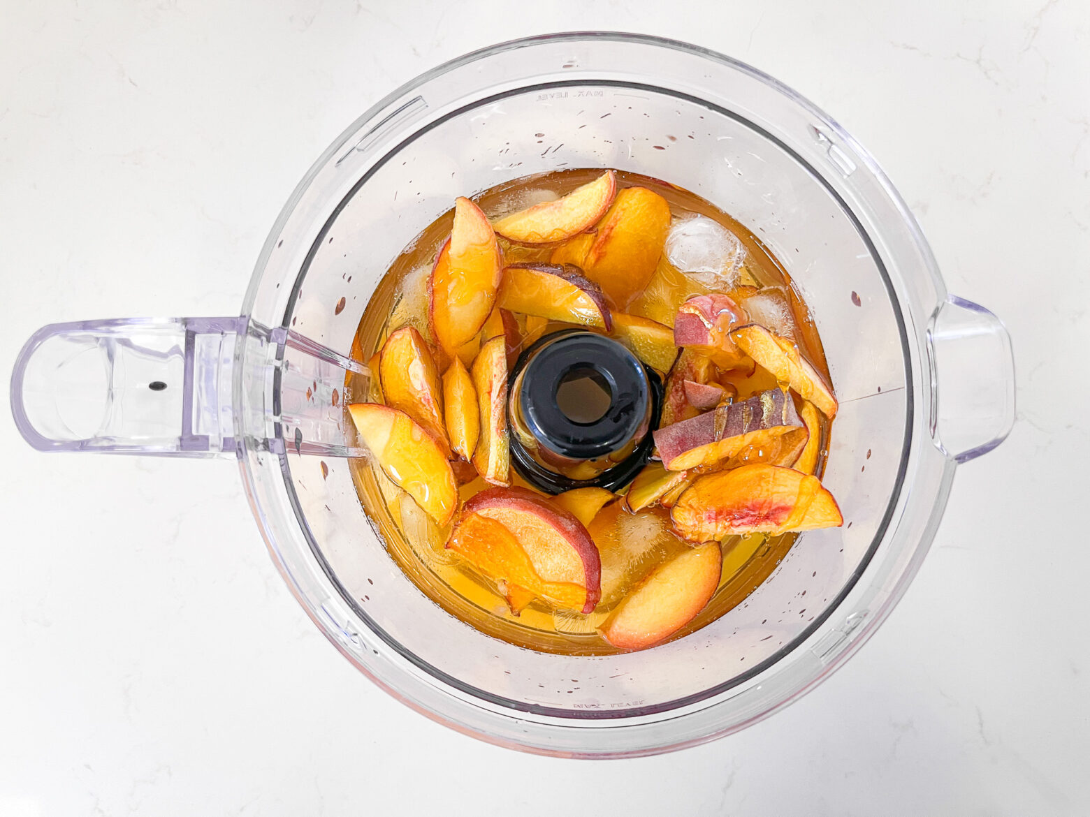 Iced peach green tea in a food processor.