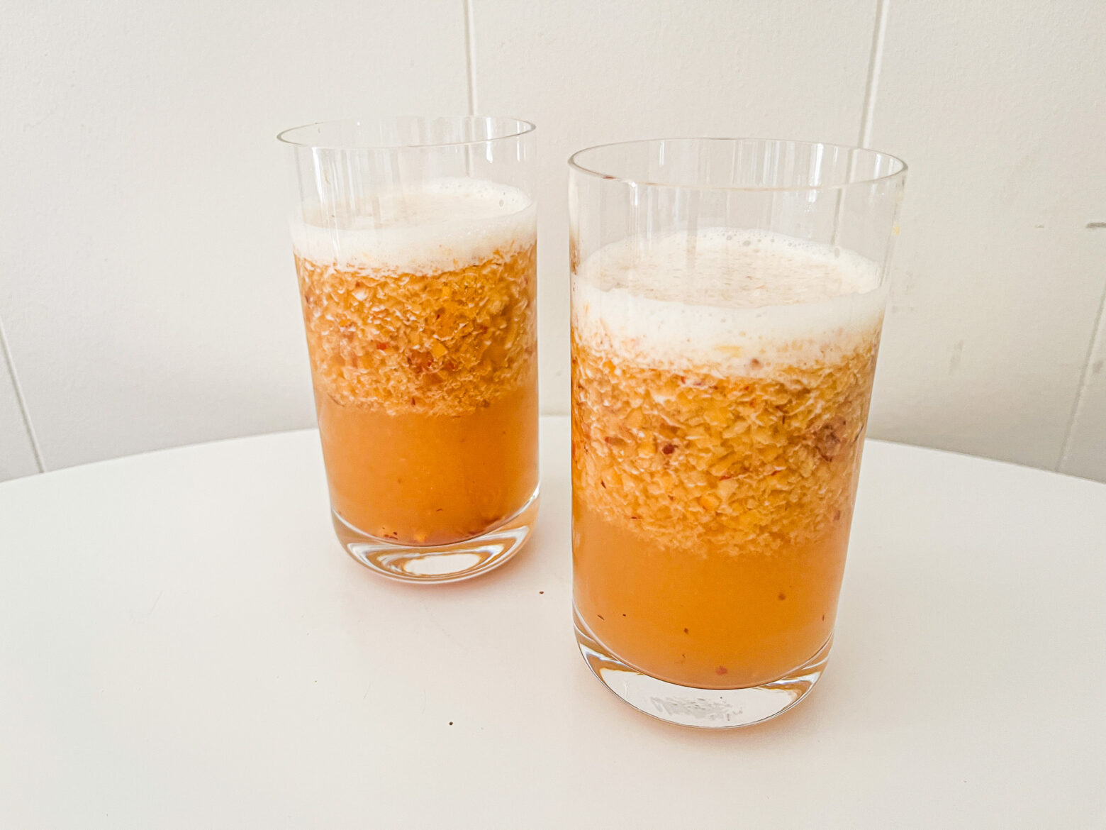 Iced green peach tea finished in two glasses.