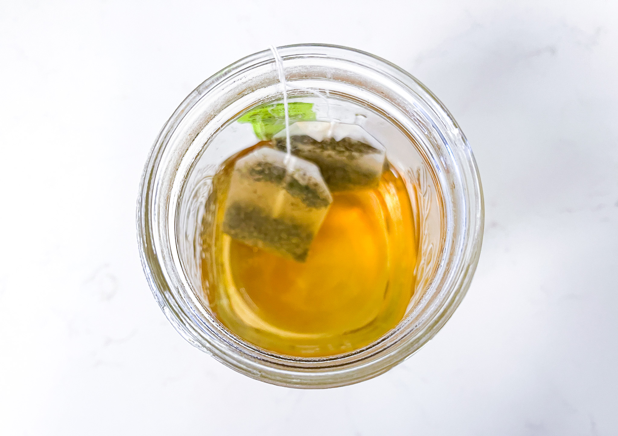 Iced green peach tea in a mason jar. 