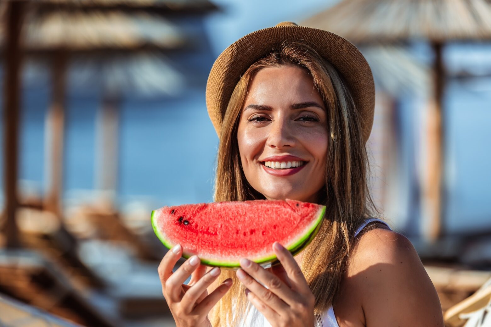 women holding a watermelon and smiling