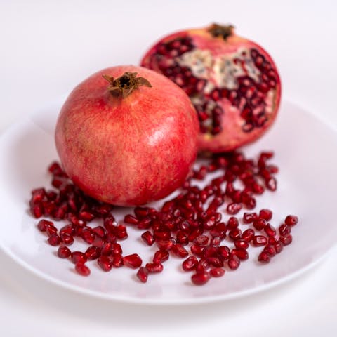 Close-Up Shot of Fresh Pomegranates on a Plate