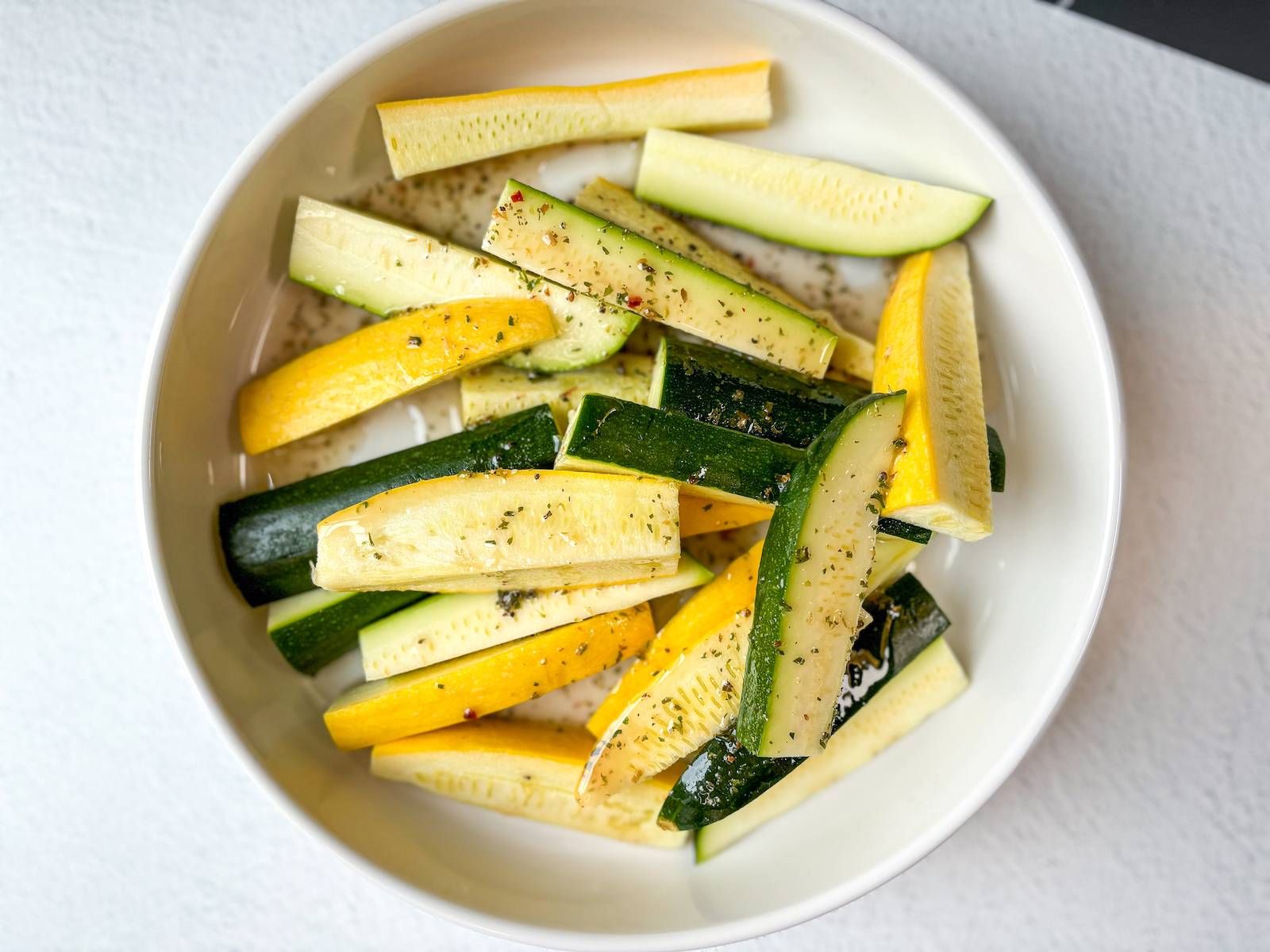 Birds eye shot of finished dressing on a plate of squash.