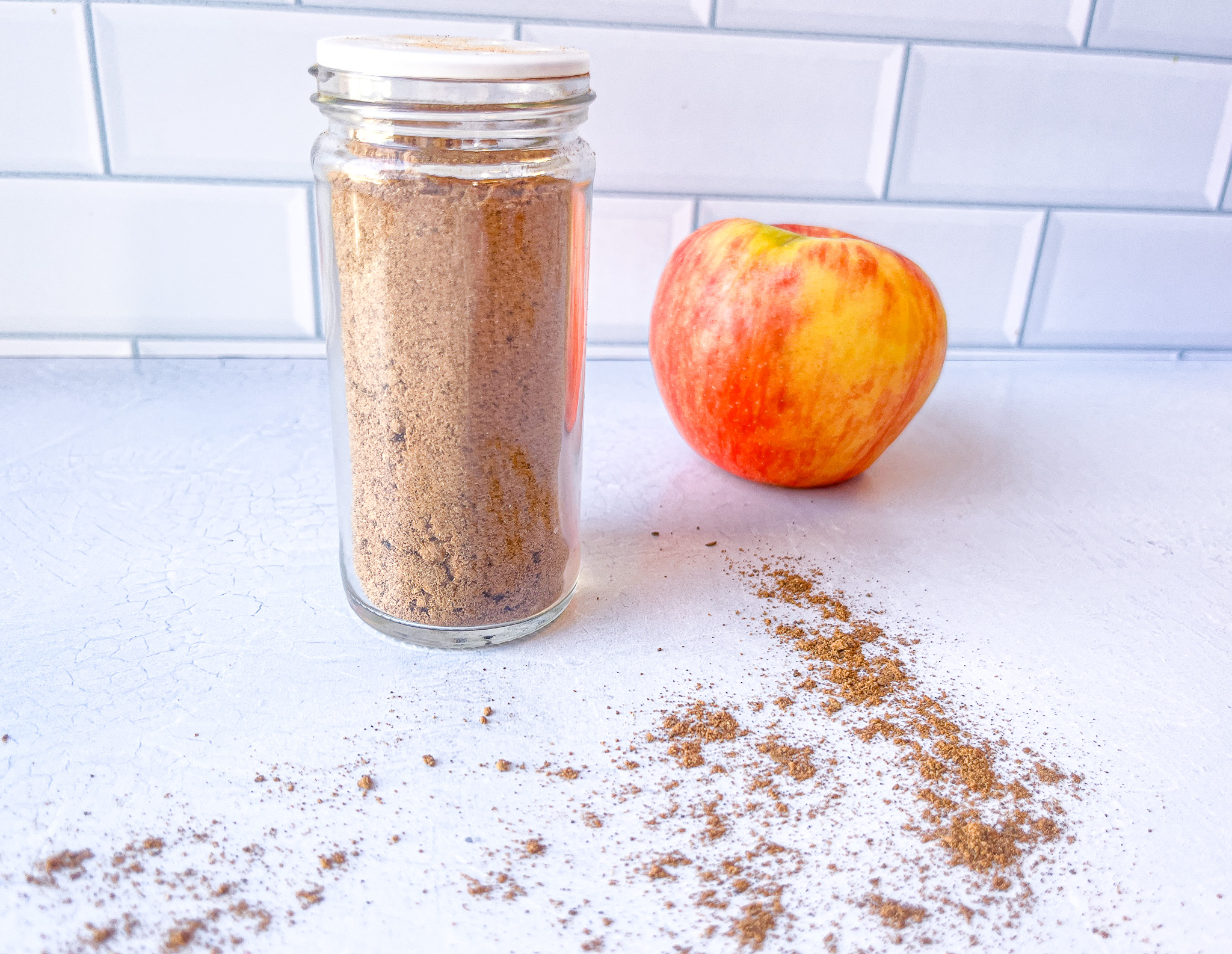 Apple pie spice next to an apple all done.