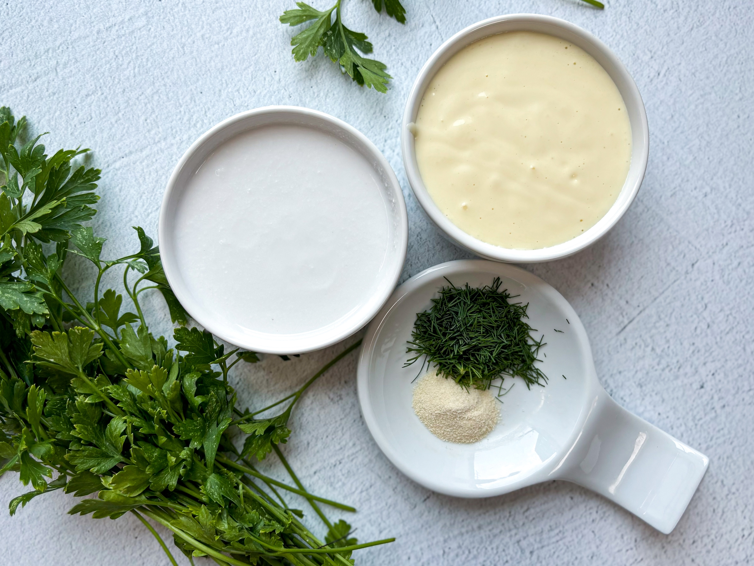 Above shot of ingredients for healthy ranch dressing, separated 