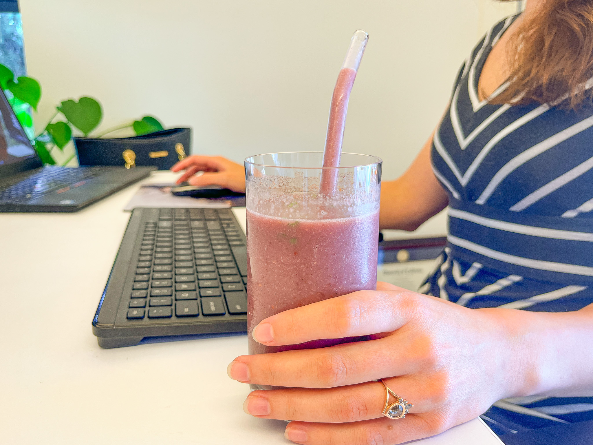 Berry Broccoli Smoothie on someone's desk.