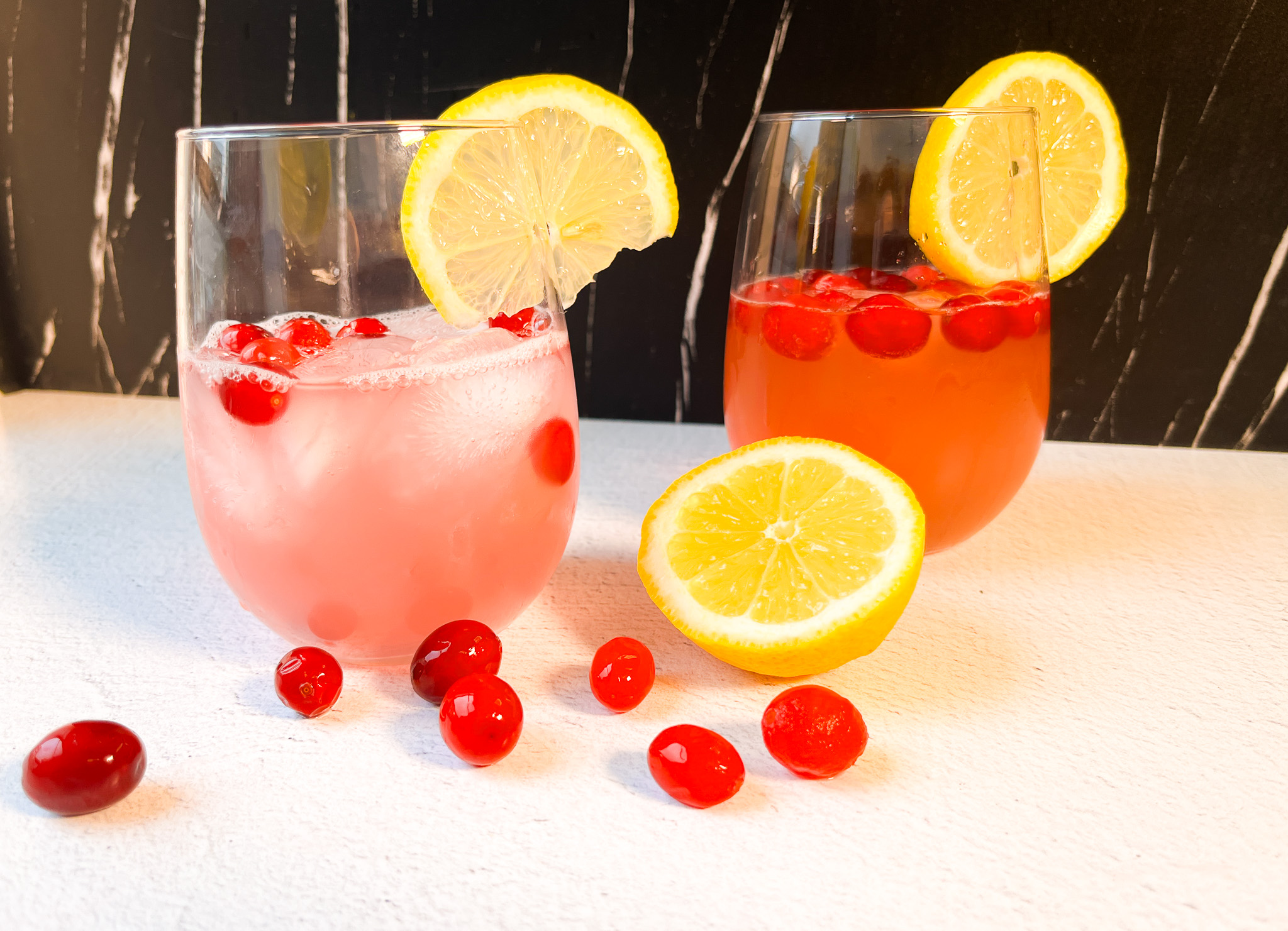 Sparkling citrus digestif finished in glasses with a lemon slice. 