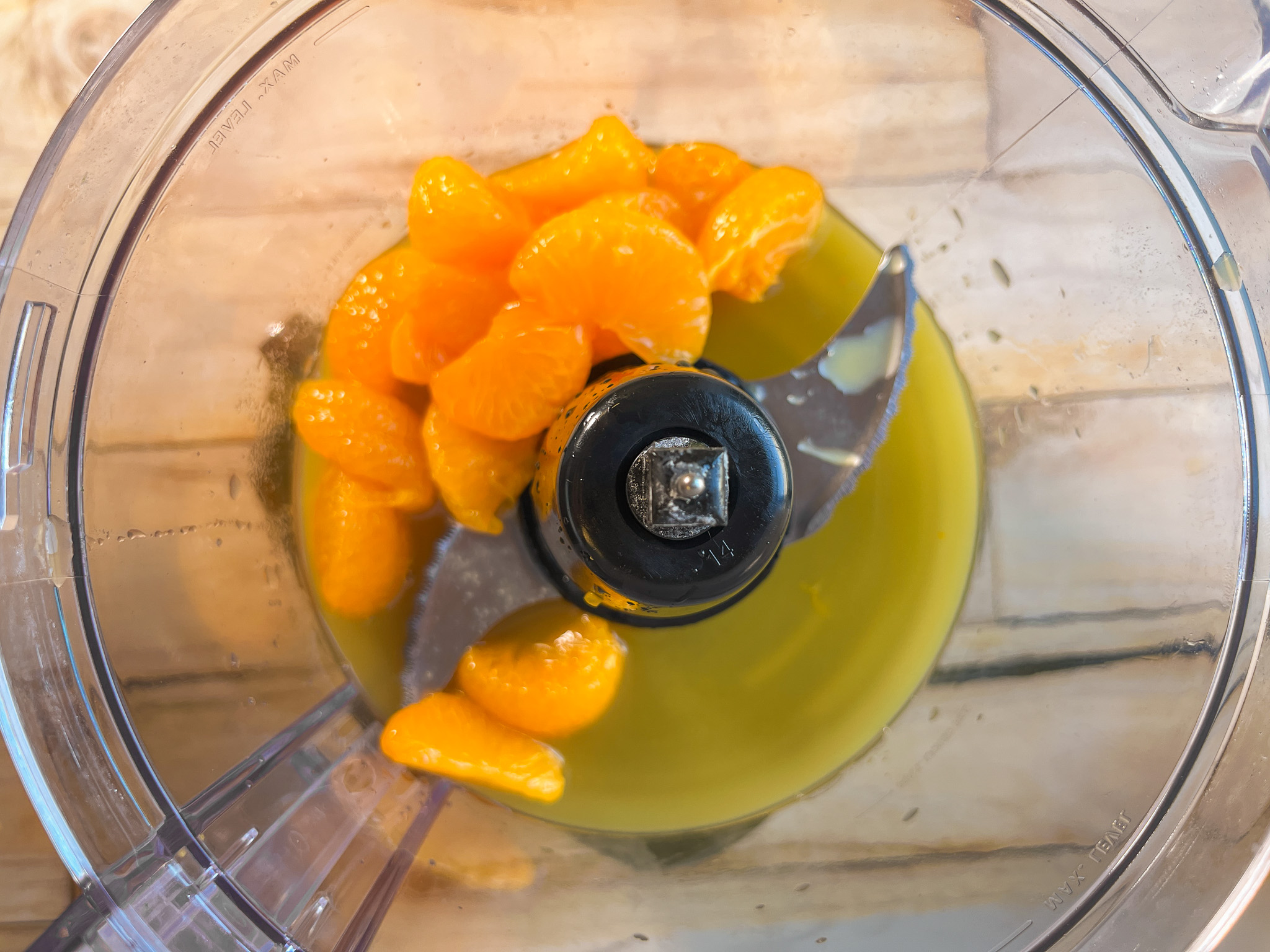 Oranges and pineapple juice in a food processor.