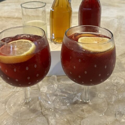 Two glasses of citrus and bitters mocktail on a kitchen counter