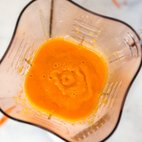 Carrot smoothie blended in blender.