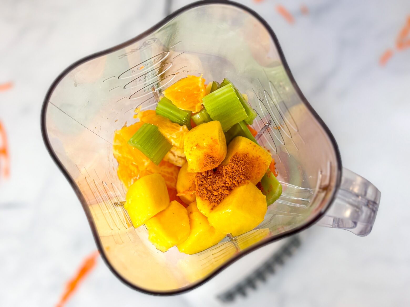 Carrot smoothie pre-blend in blender.