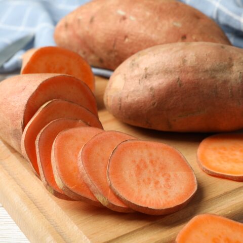 Sweet Potatoes on cutting board.