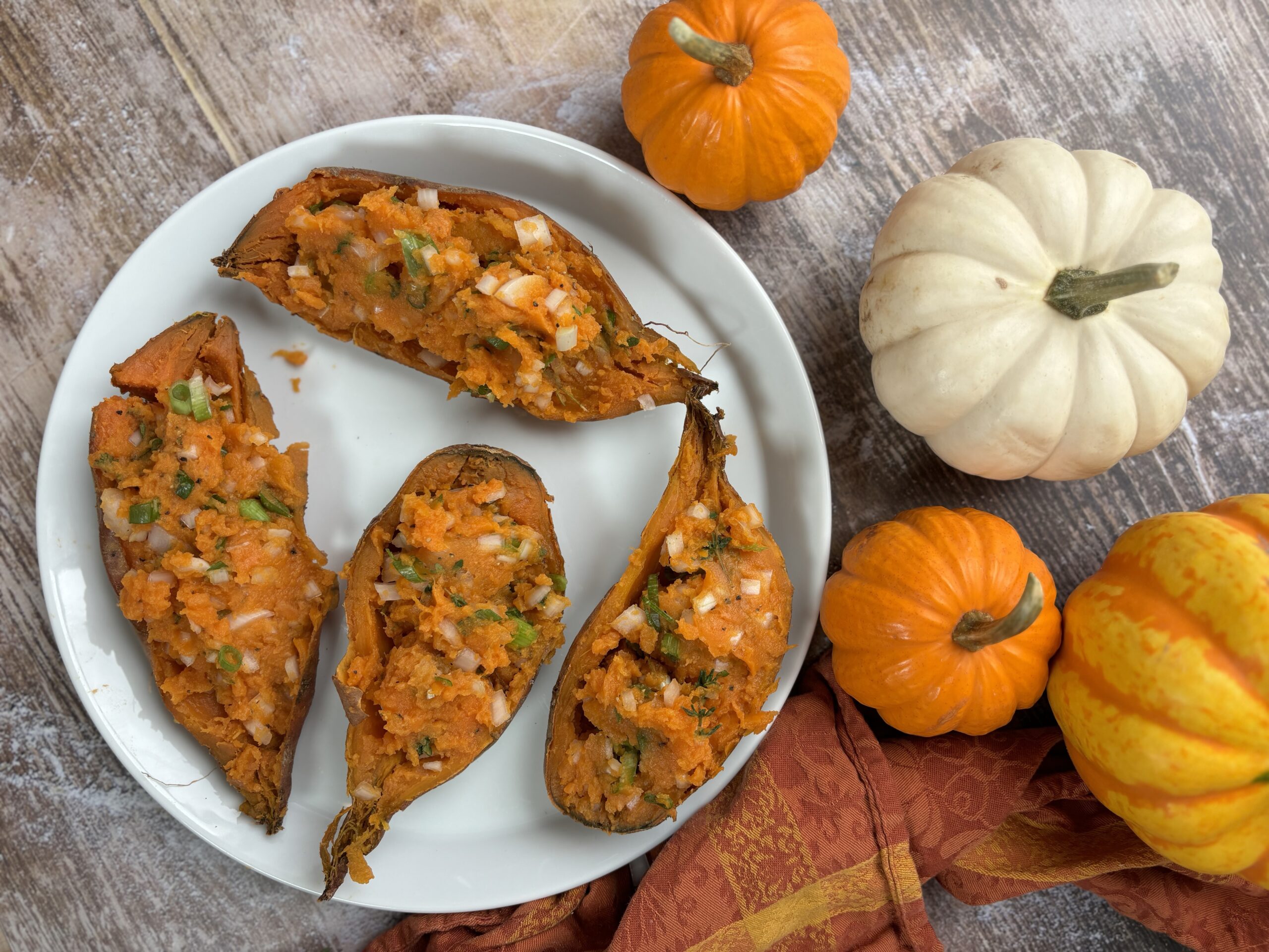 Baked sweet potatoes plated with pumpkins. 