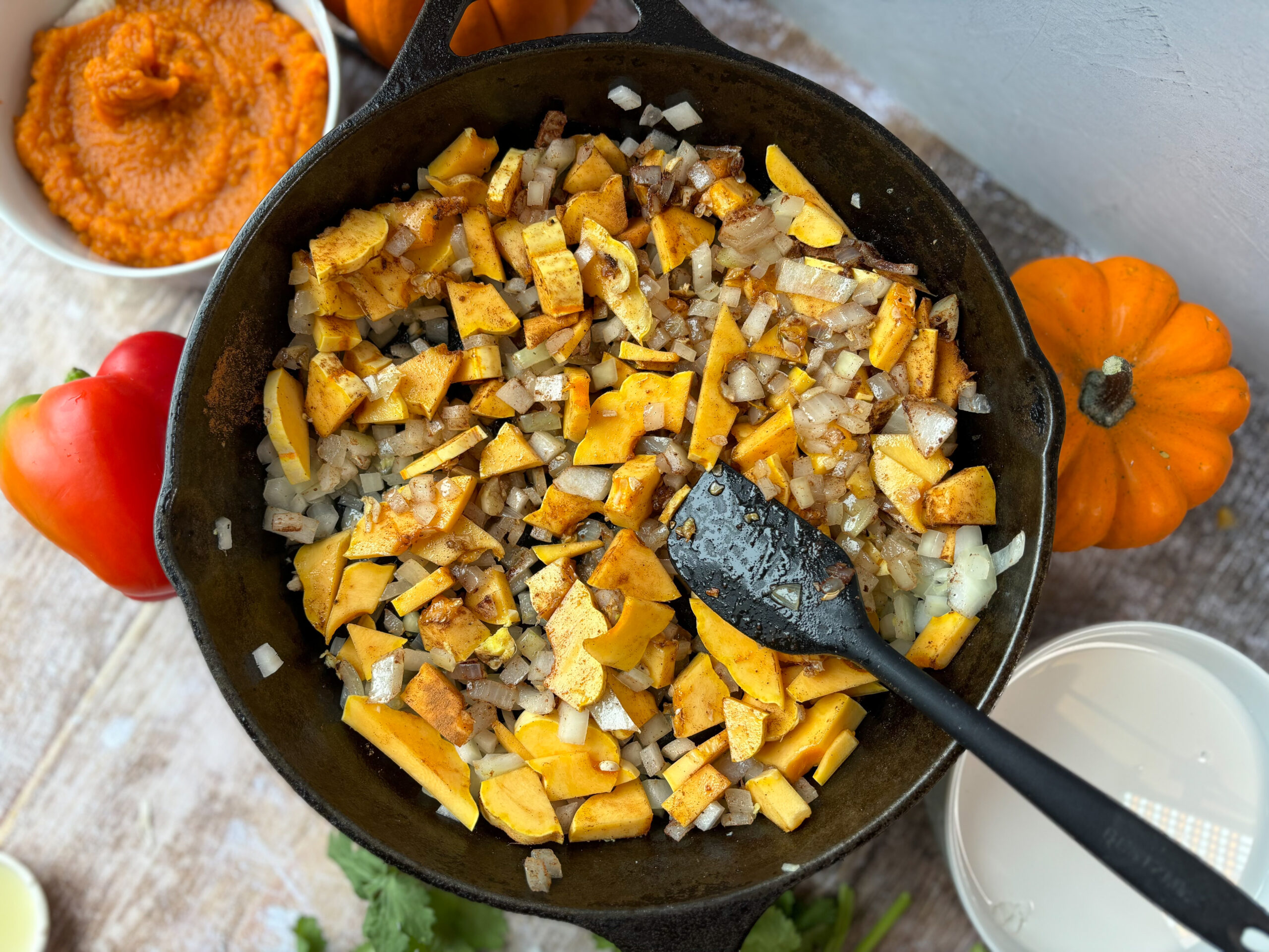 Pumpkin curry cooking in a cast iron pan.