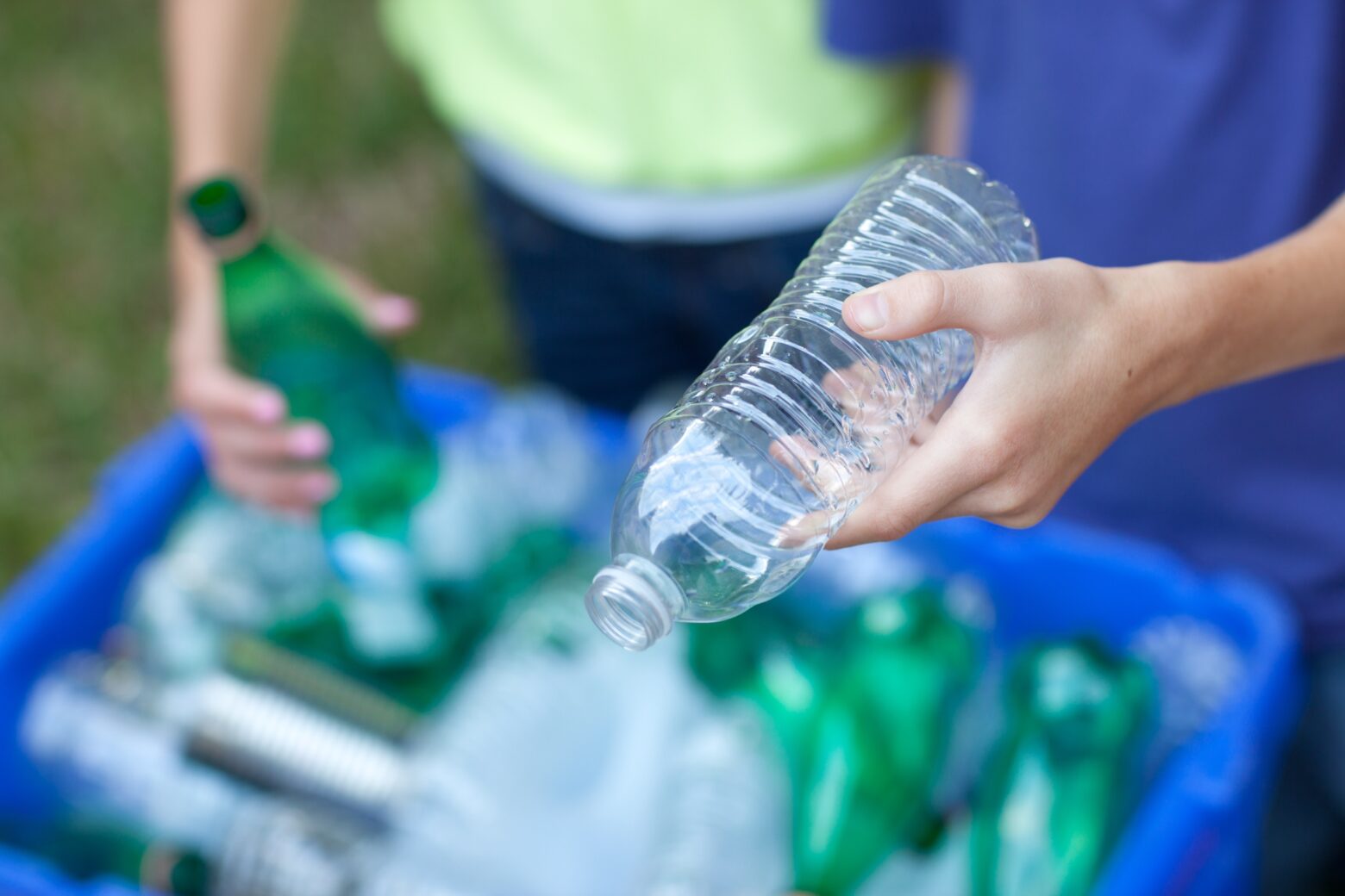 A boy and girl taking part in plastic recycling.