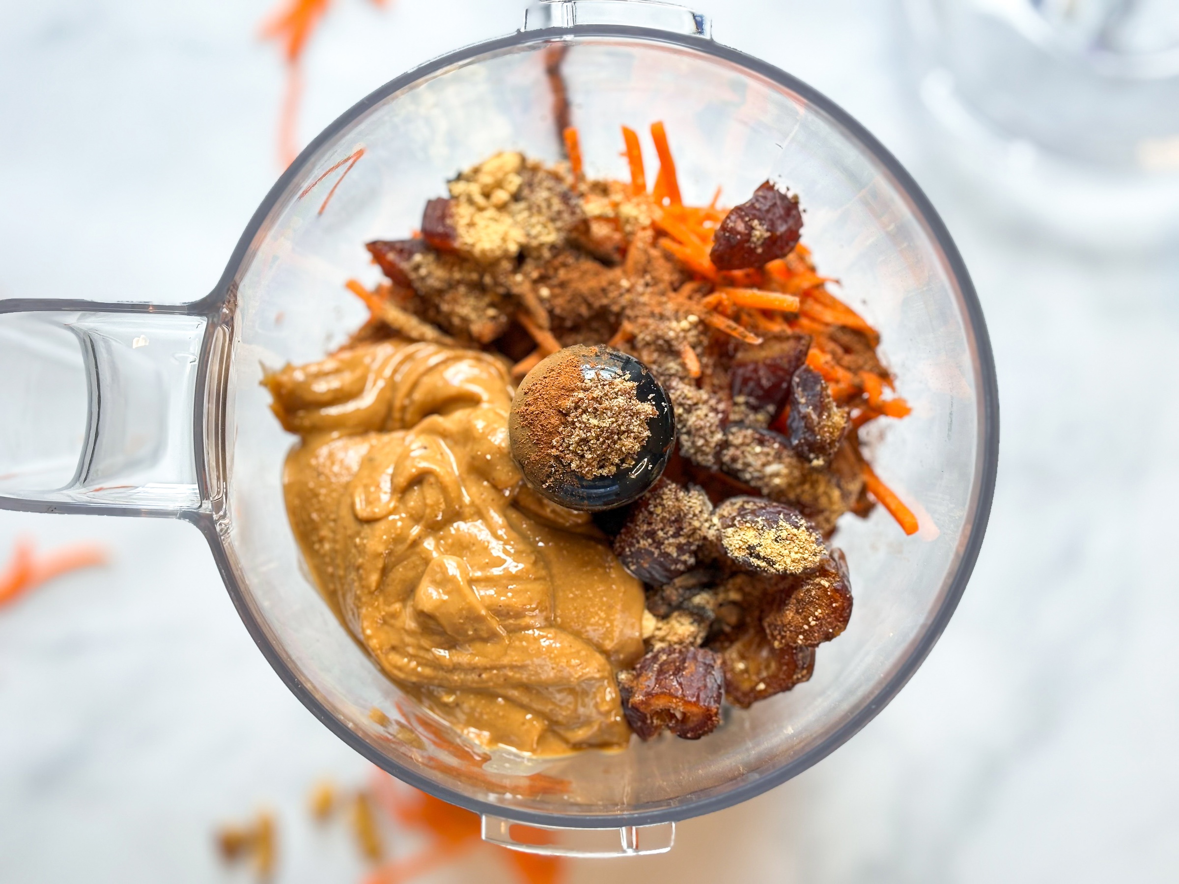 No-bake carrot cake energy balls in the food processor, before blended. 