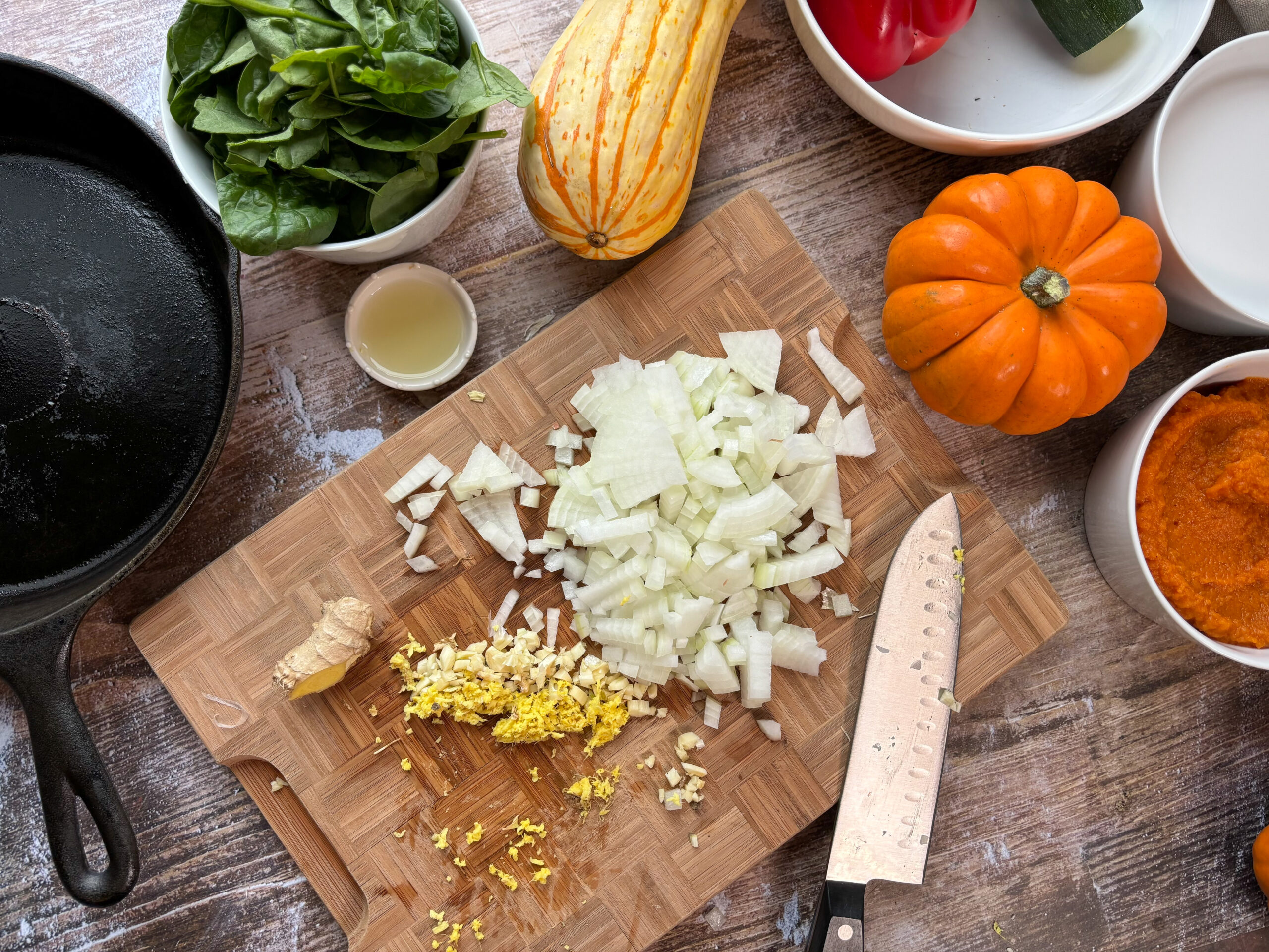 Onions and ginger being chopped for pumpkin curry.