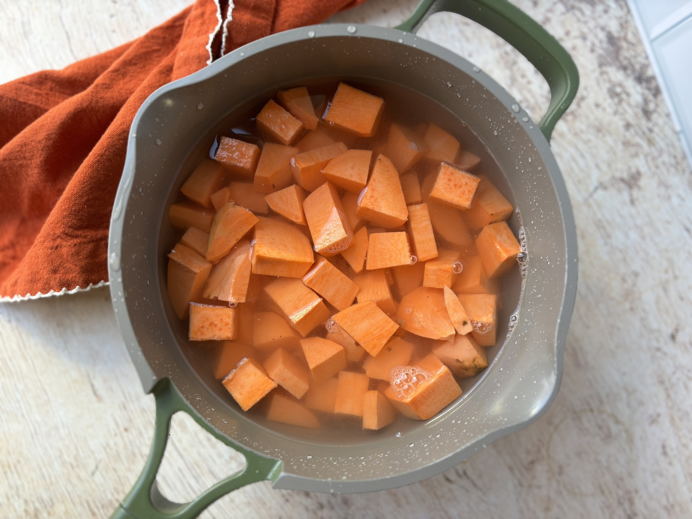 Sweet potato pie prepping cubed sweet potatoes.