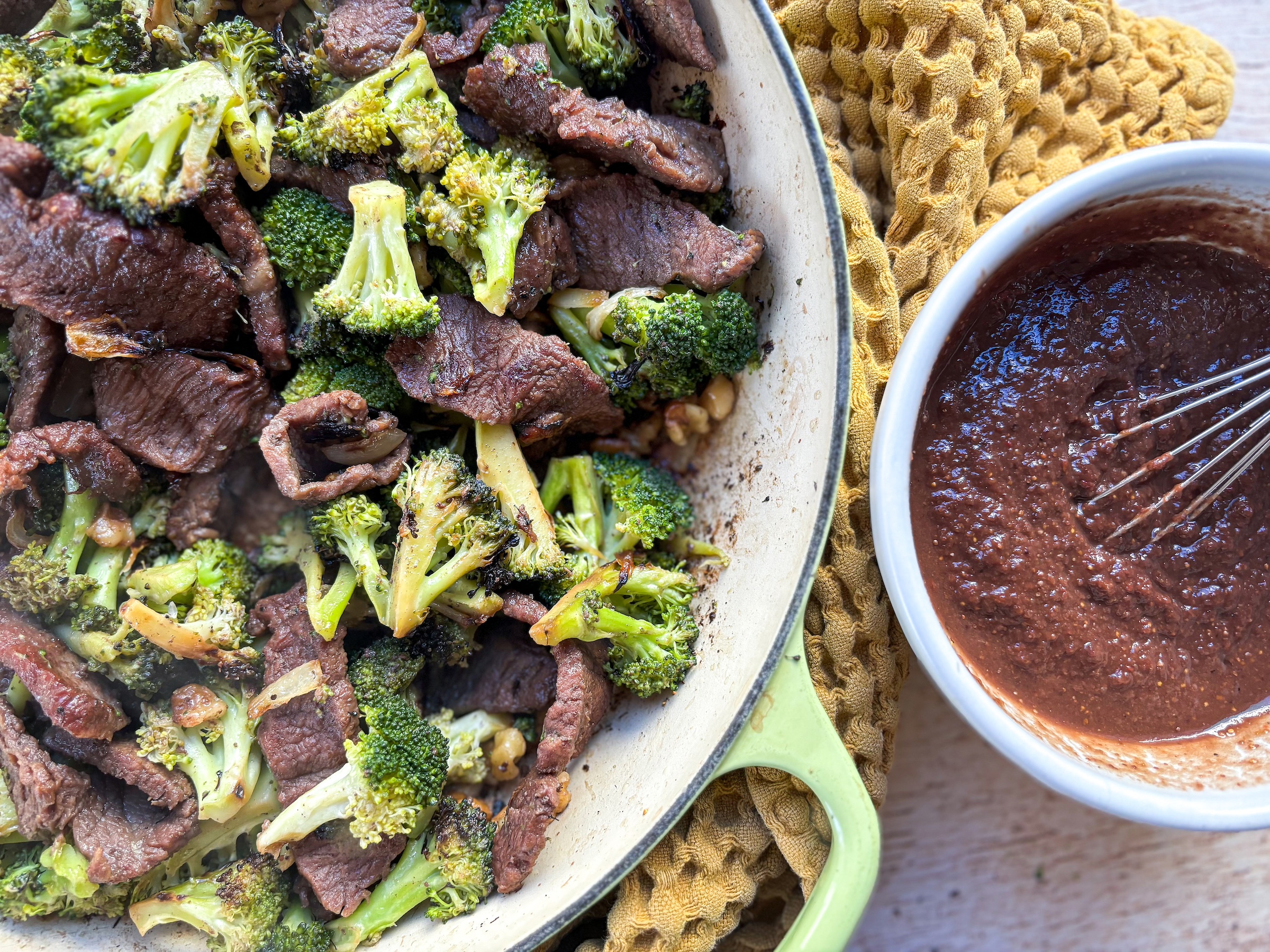 Beef and broccoli with sauce on the side. 