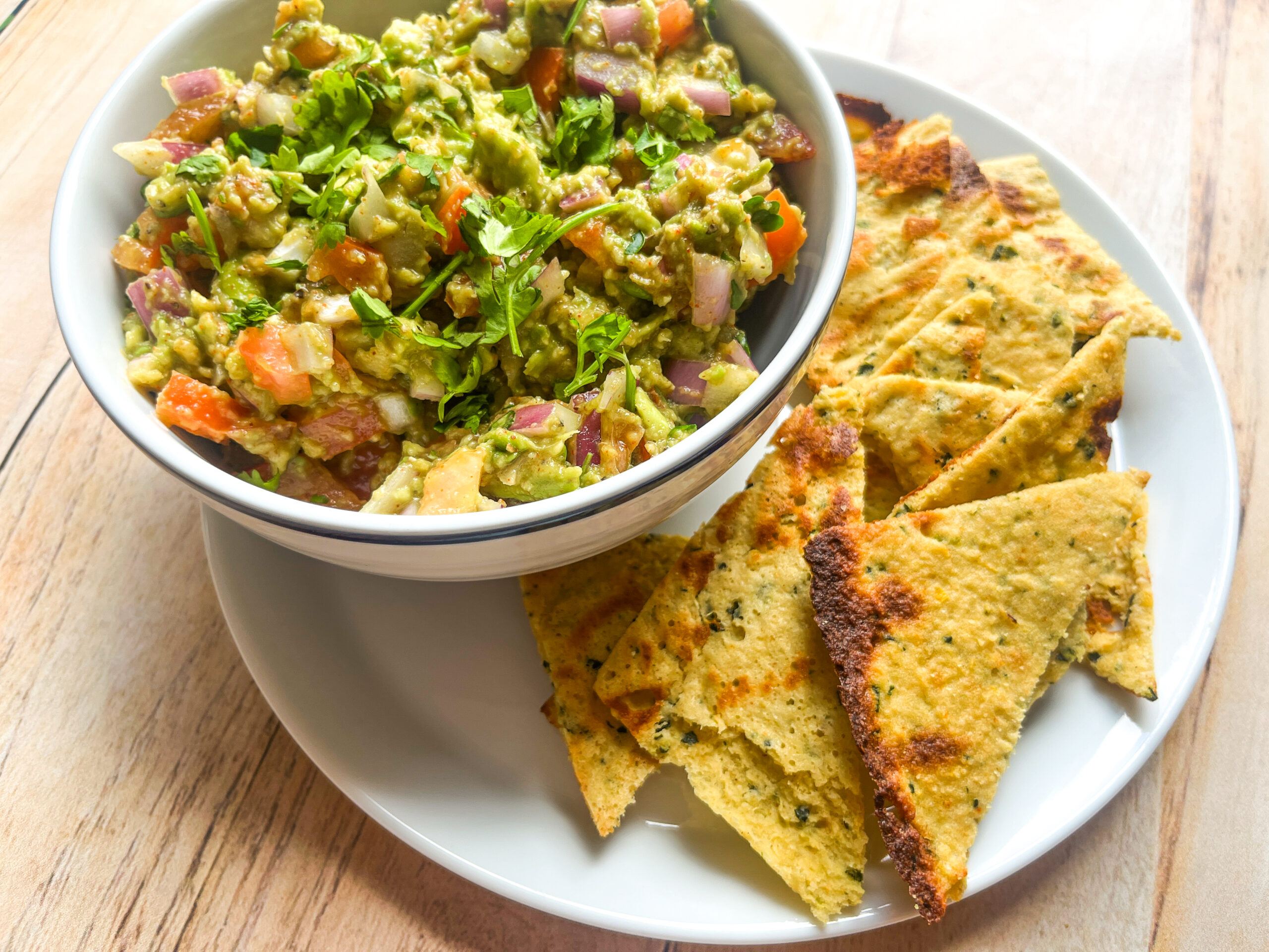 Garden veggie chips on a plate with guacamole. 