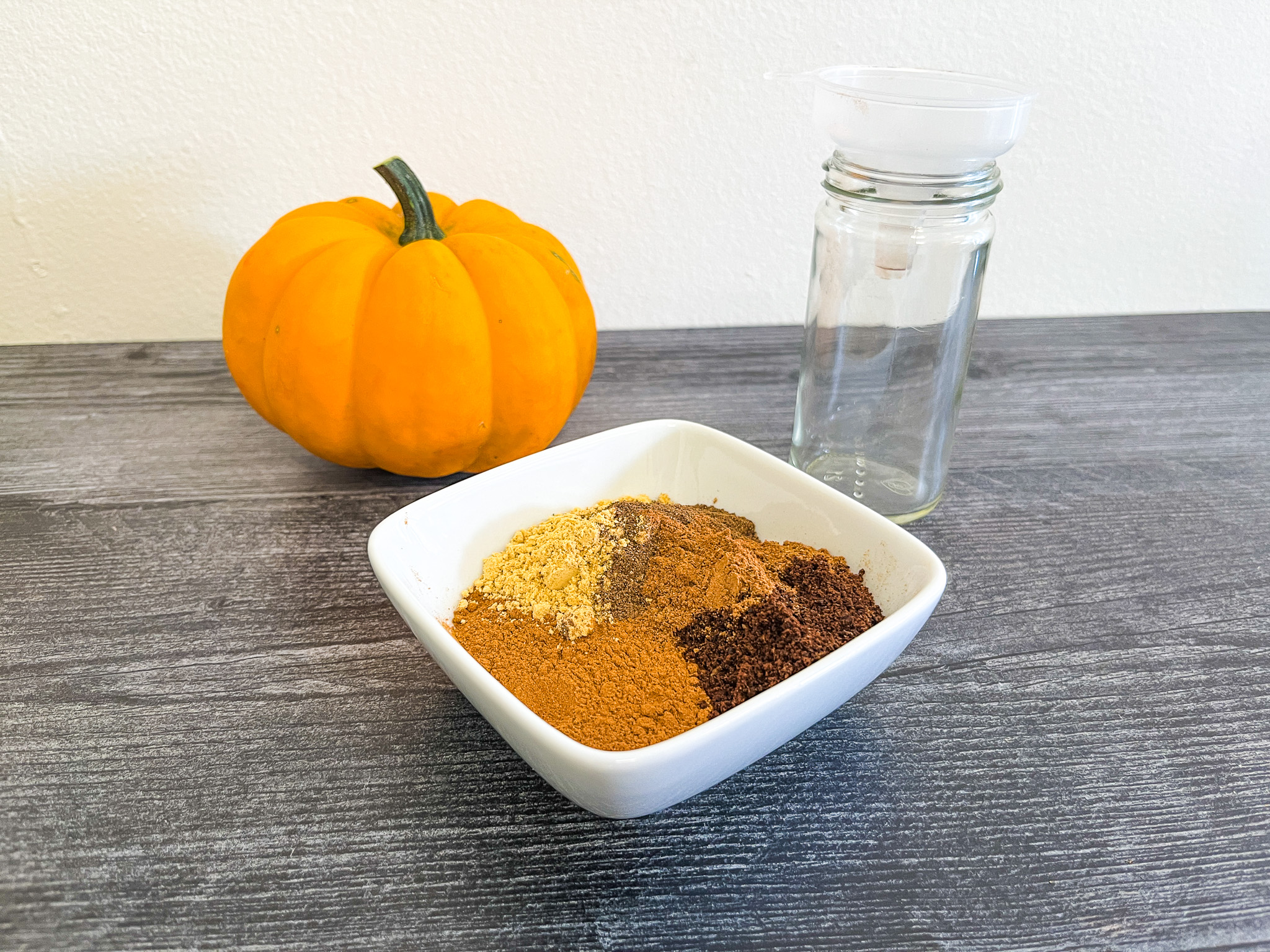 Making pumpkin pie spice while mixing all the spices.