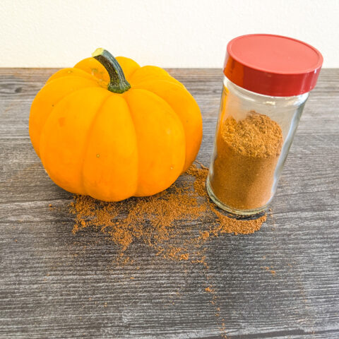 Pumpkin pie spice in a jar with a pumpkin.