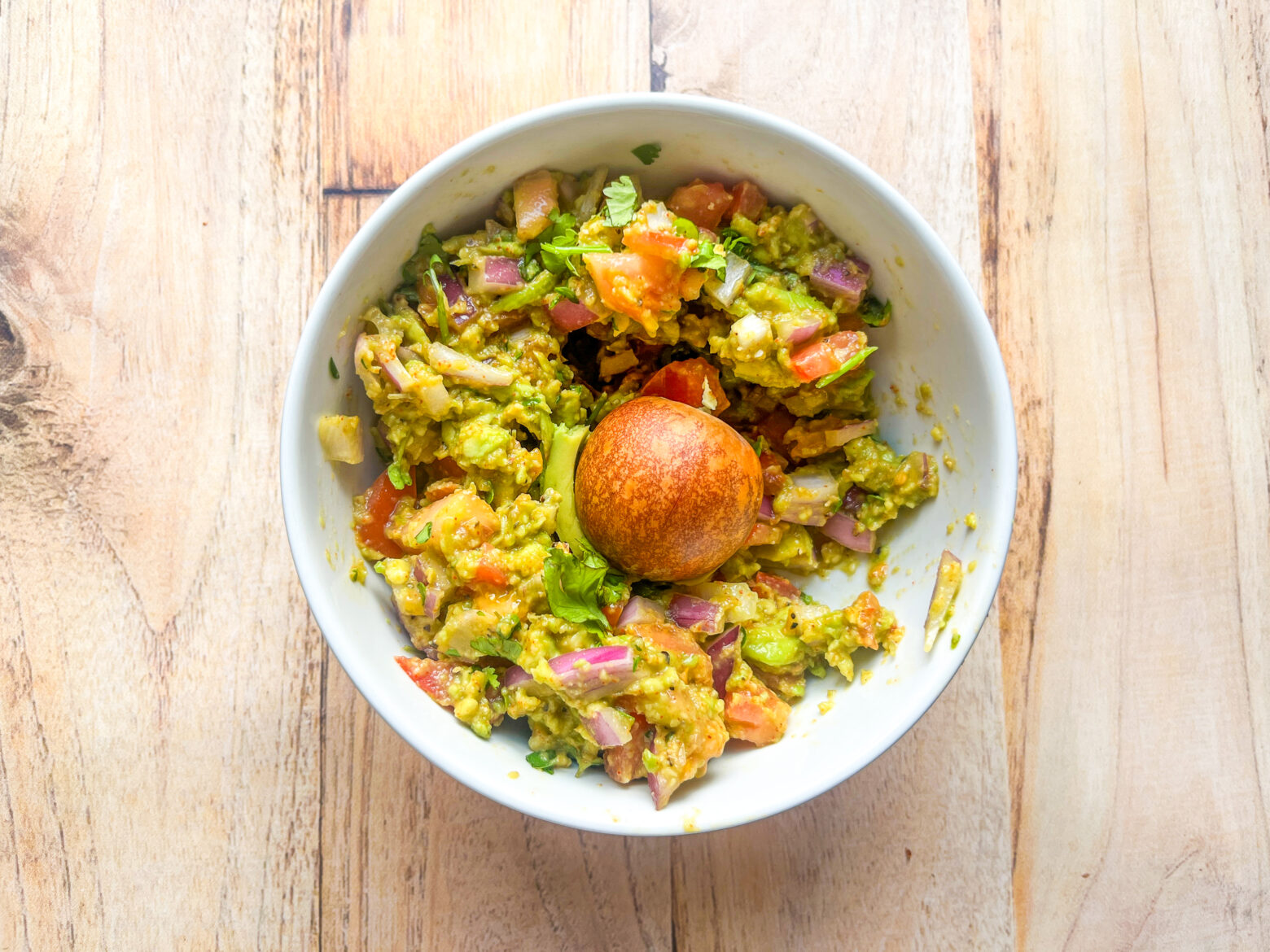 Microgreens guacamole finished with the pit in it.