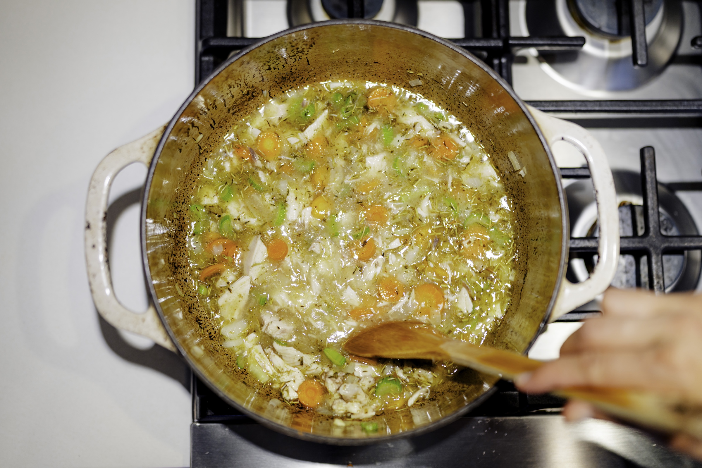 Mustard chicken soup cooking on the stove. 