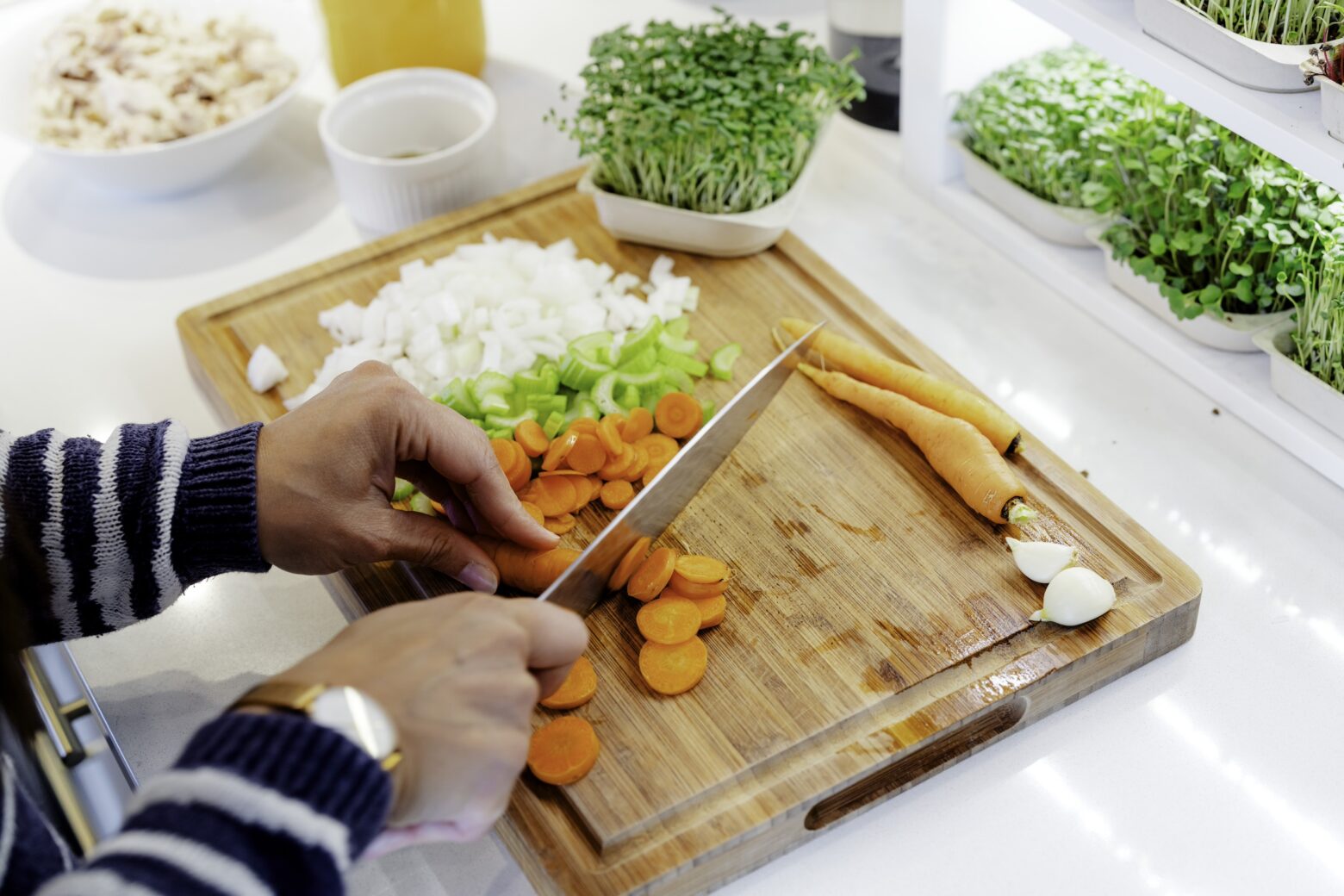 Carrots being chopped for mustard chicken soup recipe.
