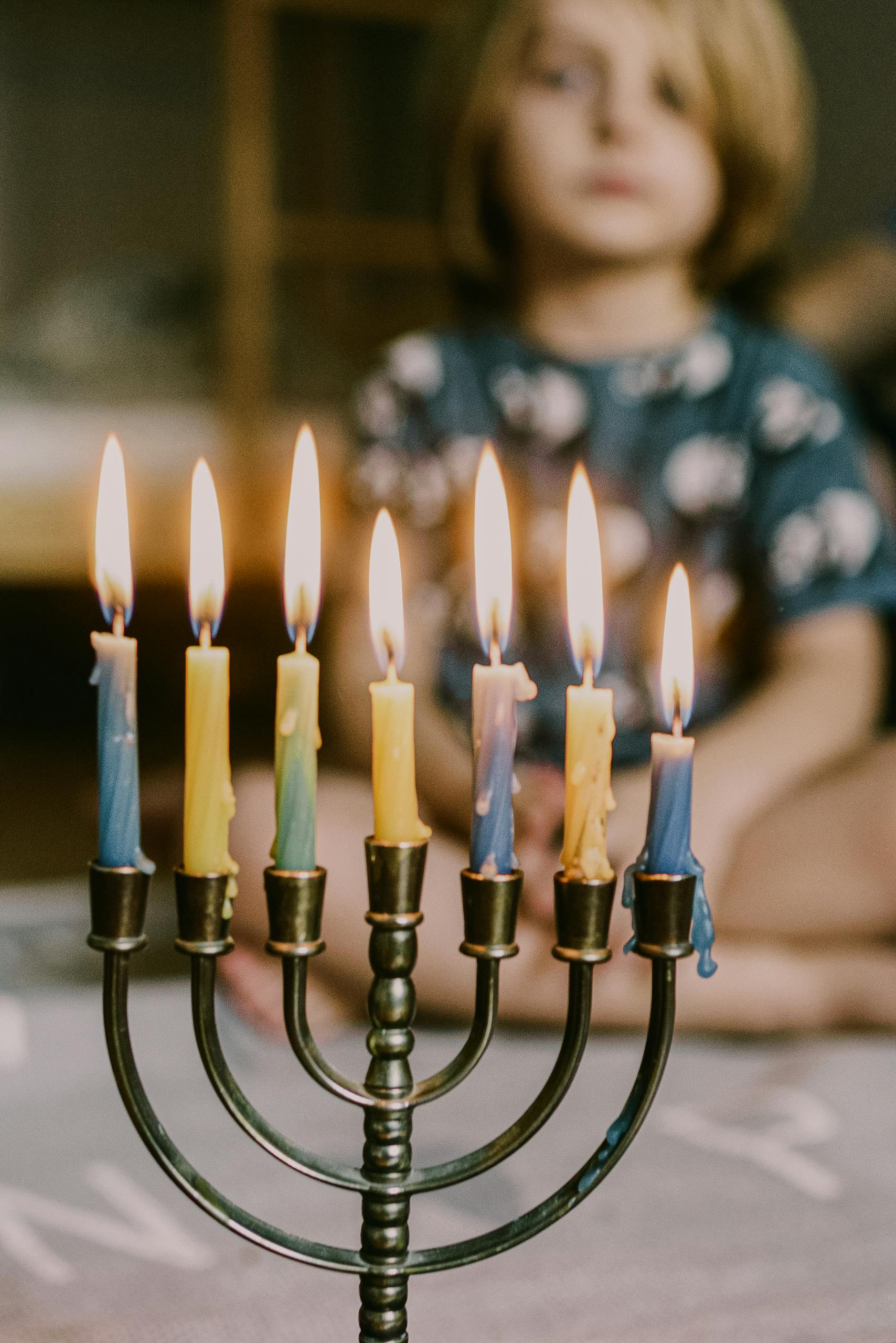 A young child infant of a menorah celebrating.