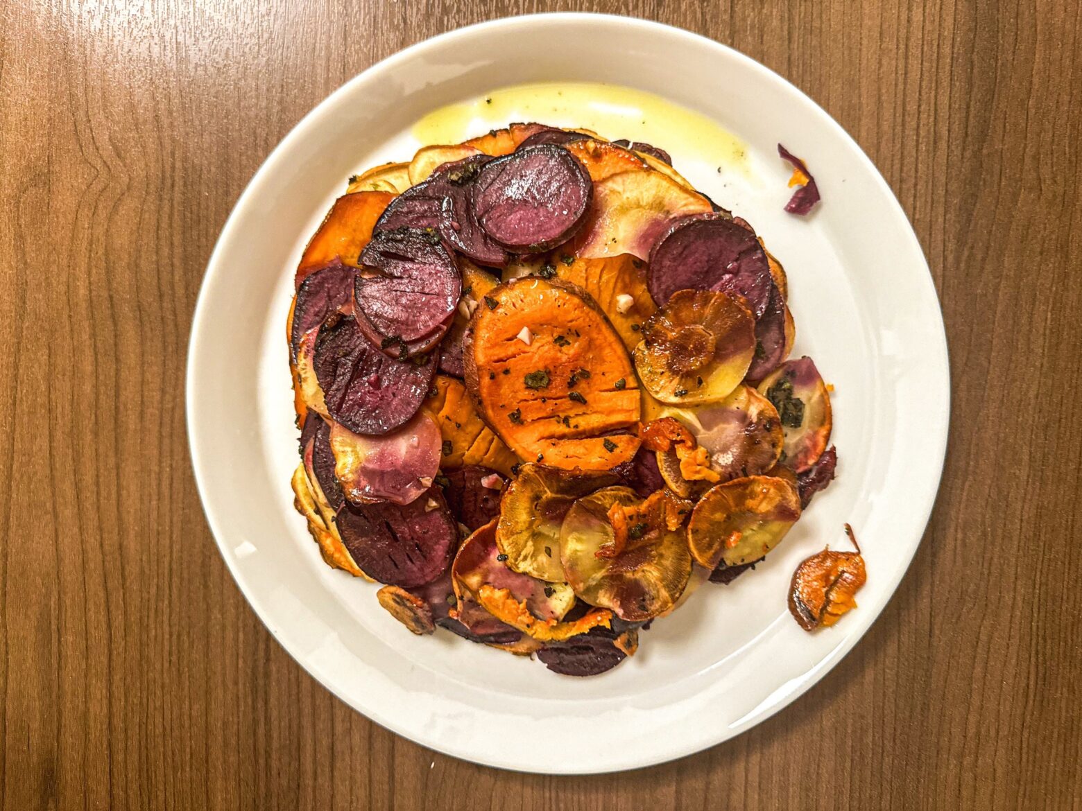 Sweet potato pommes anna plated in a dish.