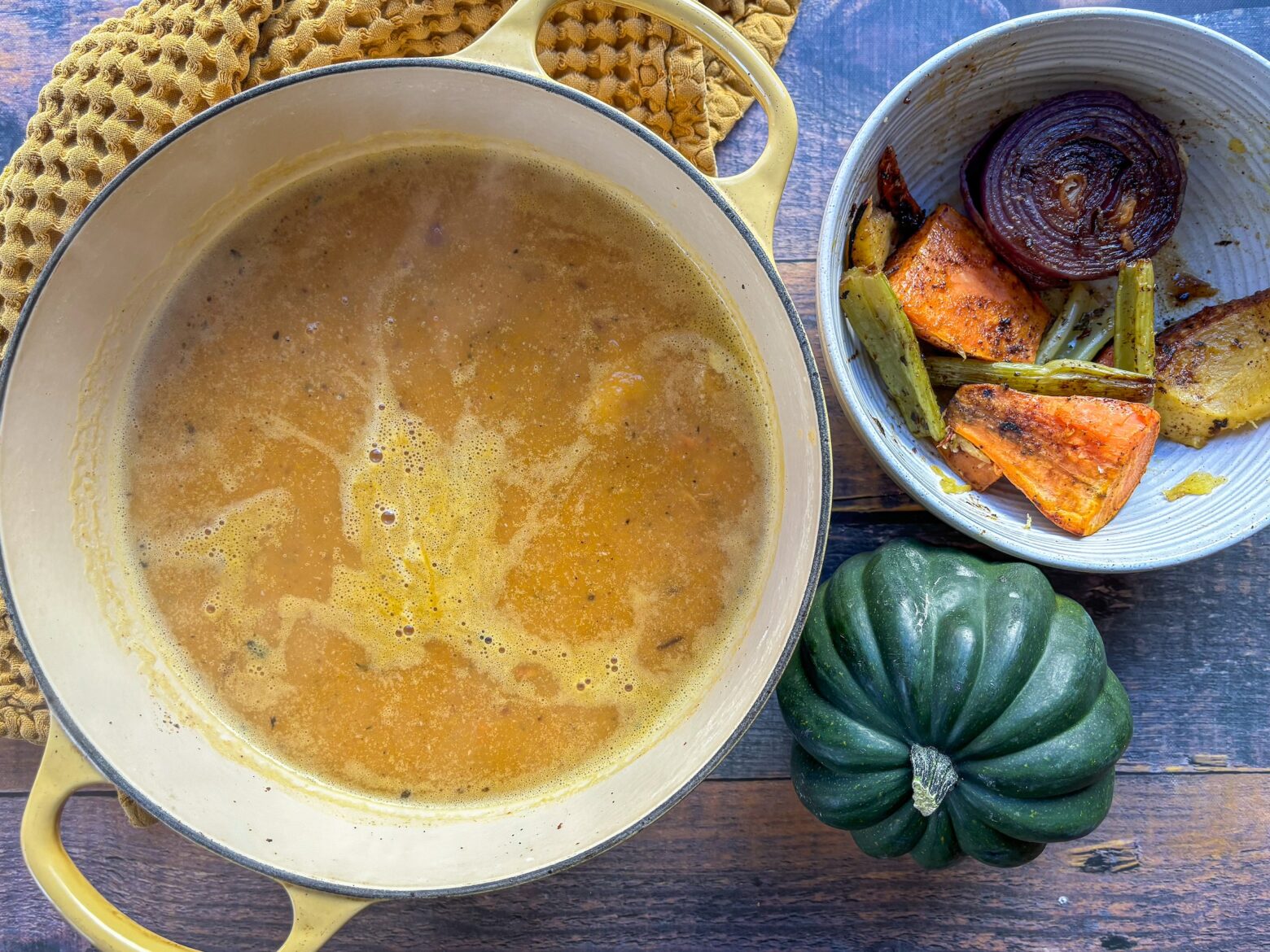 Roasted acorn squash soup in a pot.
