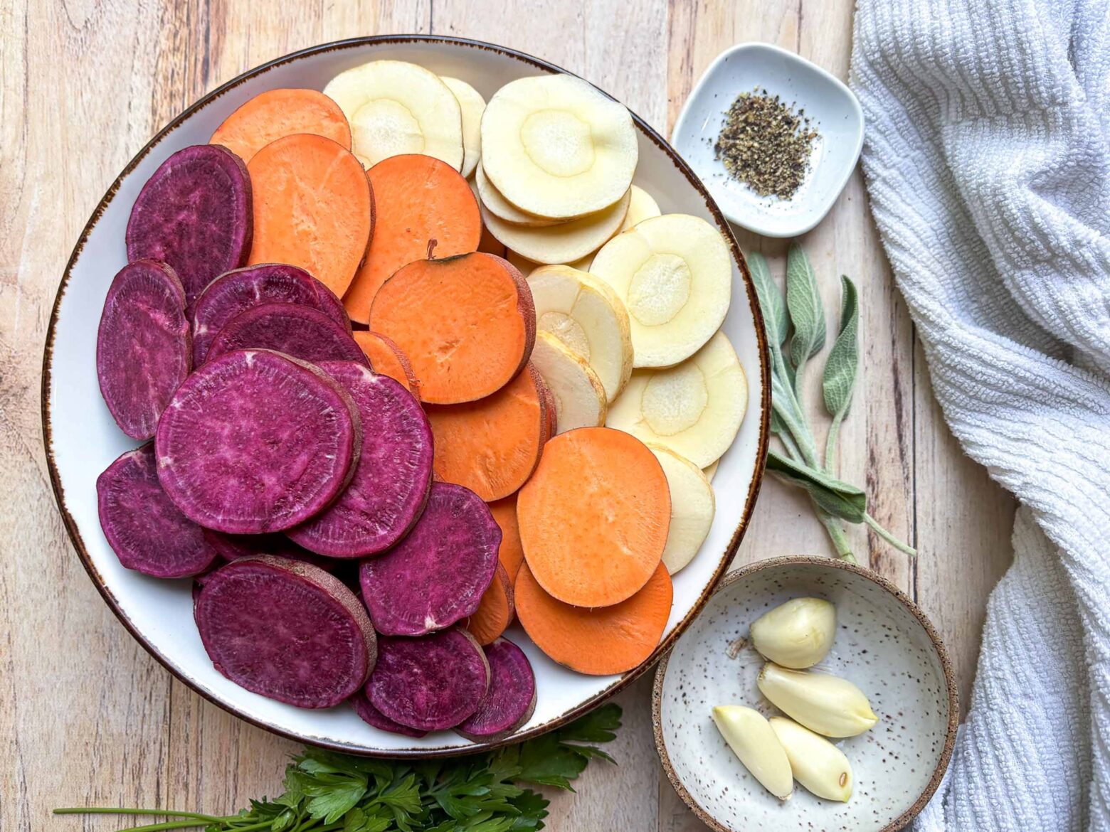 Root vegetables sliced and organized on a plate.