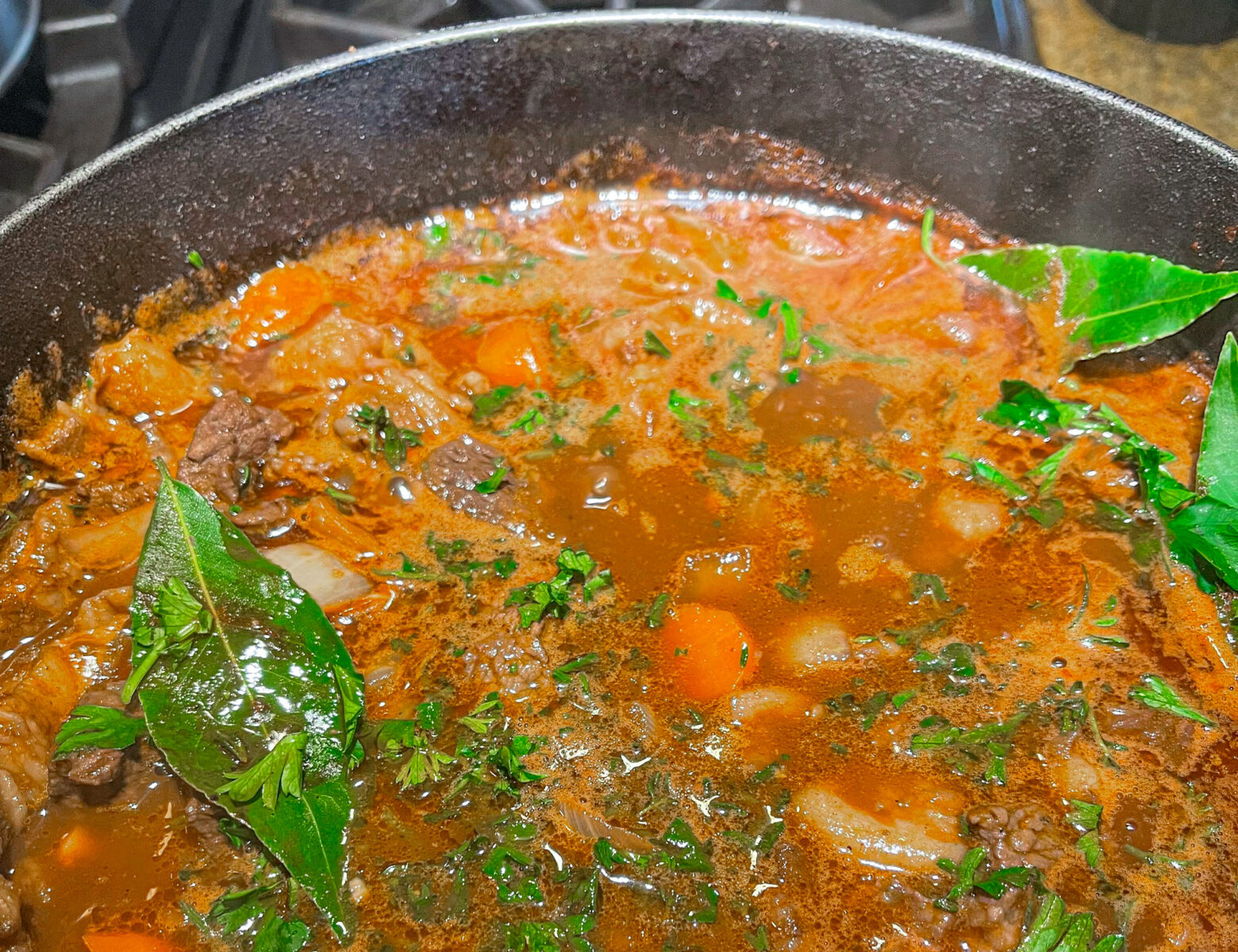 Beef bourguignon in a cast iron over the stove.