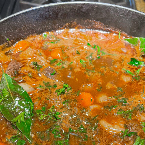 Beef bourguignon in a cast iron over the stove.