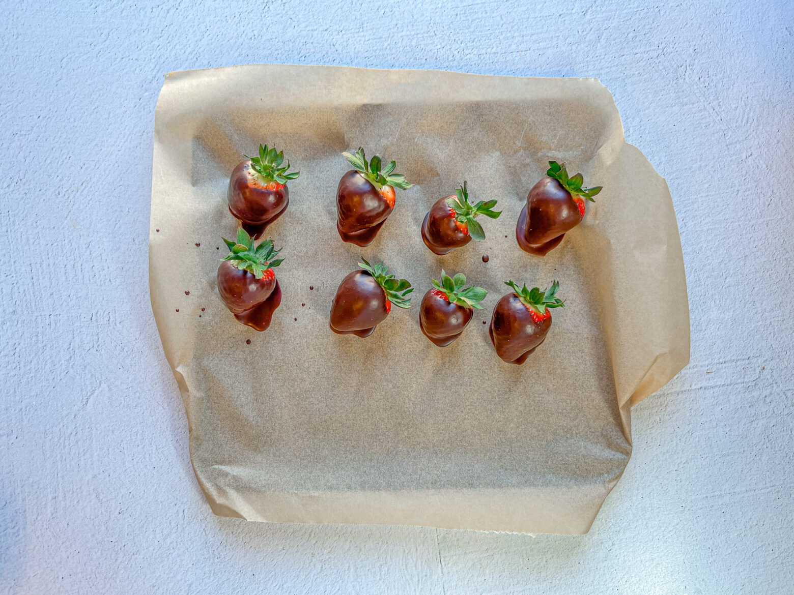 Chocolate-covered strawberries finished on a baking tray. 