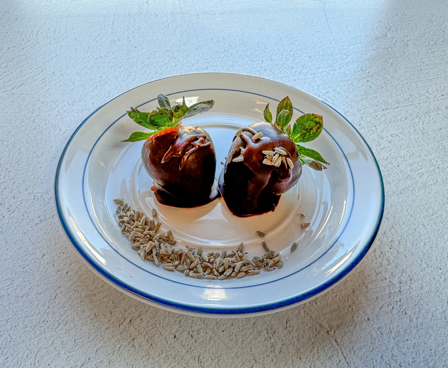 Lavender chocolate-covered strawberries finished on a plate.