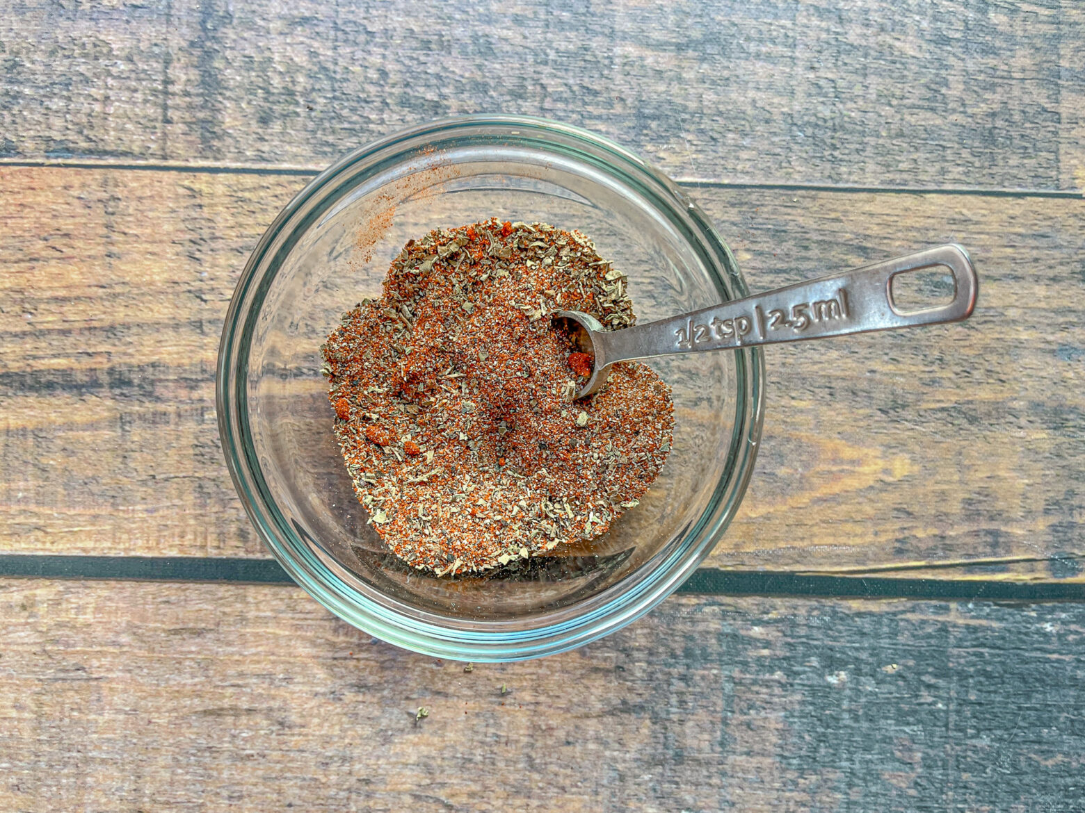 Cajun seasoning mixed in a glass bowl.