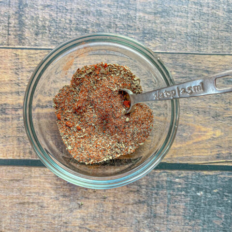 Cajun seasoning mixed in a glass bowl.